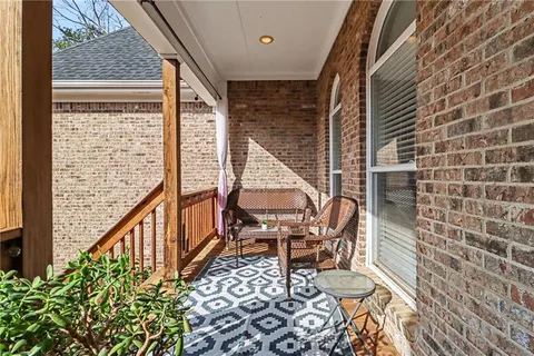 a balcony with table and chairs