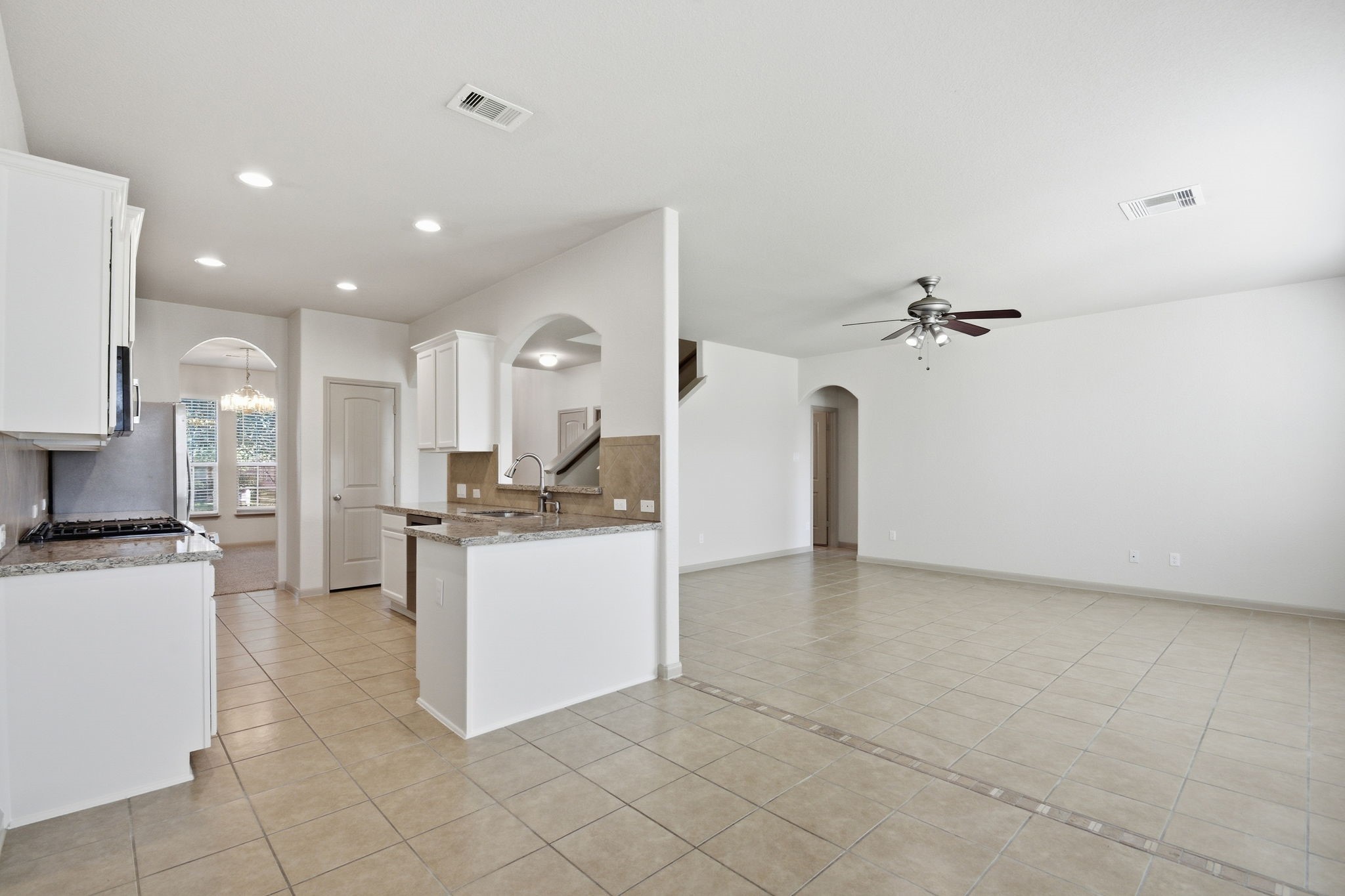 25523 Marmite Drive Tomball, TX 77375 - Photo 17 of 50 a view of a kitchen with kitchen island a sink stainless steel appliances and cabinets
