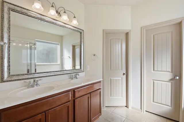 a bathroom with a tub a sink and a mirror