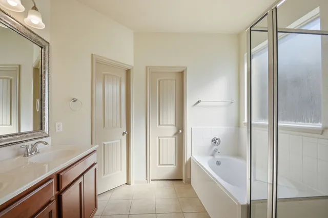 a bathroom with a bathtub and a shower