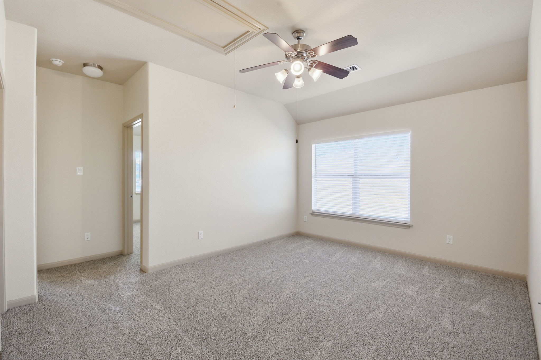 25523 Marmite Drive Tomball, TX 77375 - Photo 31 of 50 an empty room with chandelier fan and windows