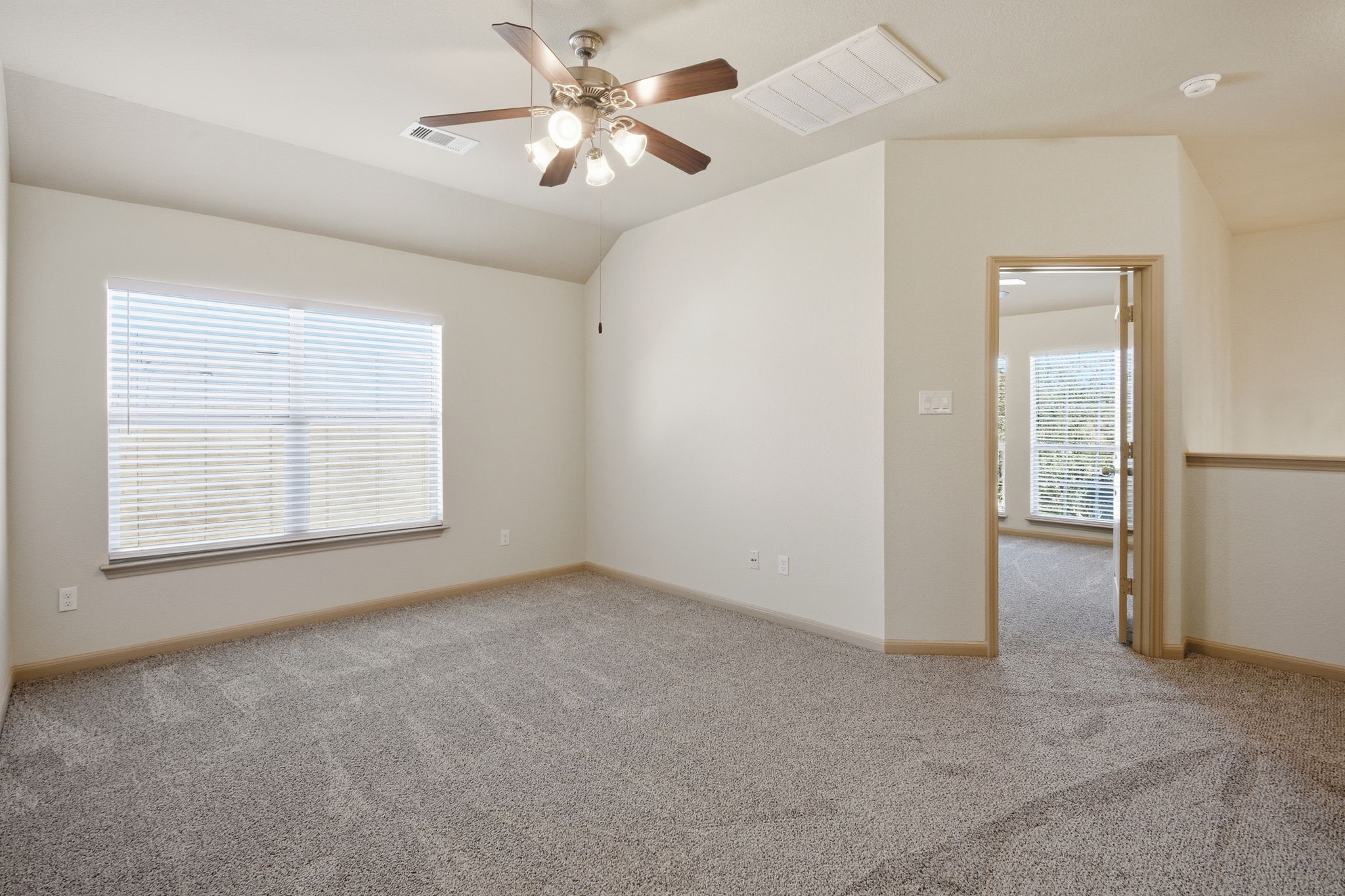 25523 Marmite Drive Tomball, TX 77375 - Photo 32 of 50 an empty room with chandelier fan and windows