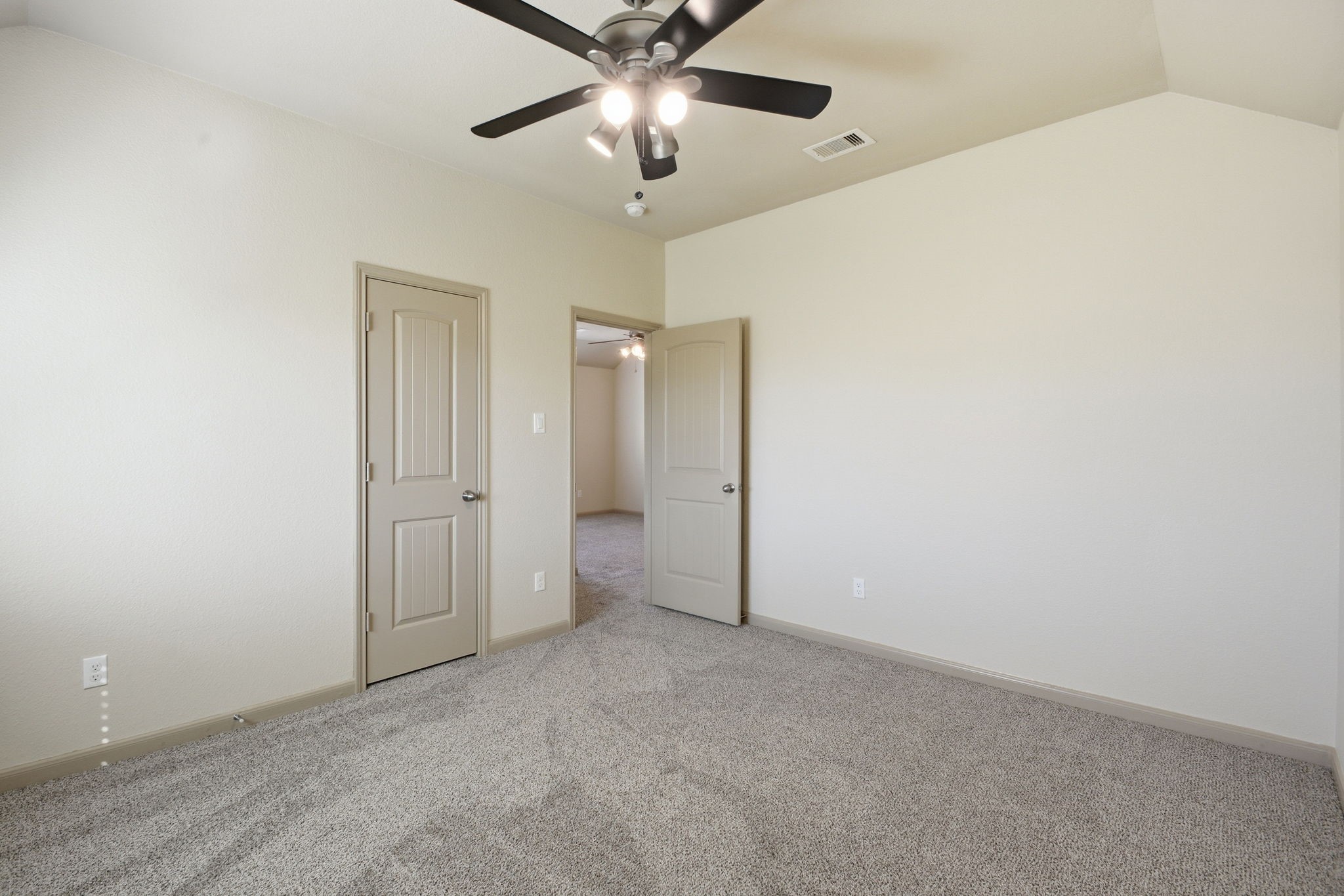 25523 Marmite Drive Tomball, TX 77375 - Photo 42 of 50 an empty room with closet and a chandelier fan