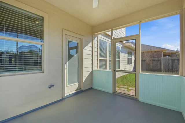 a view of a backyard with table and chairs and wooden fence