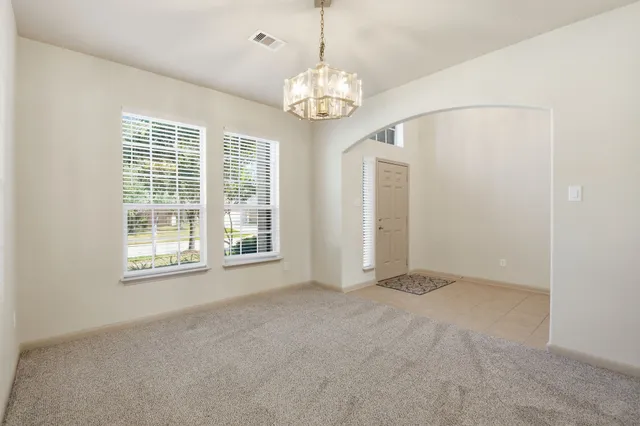 a view of a hallway with a chandelier