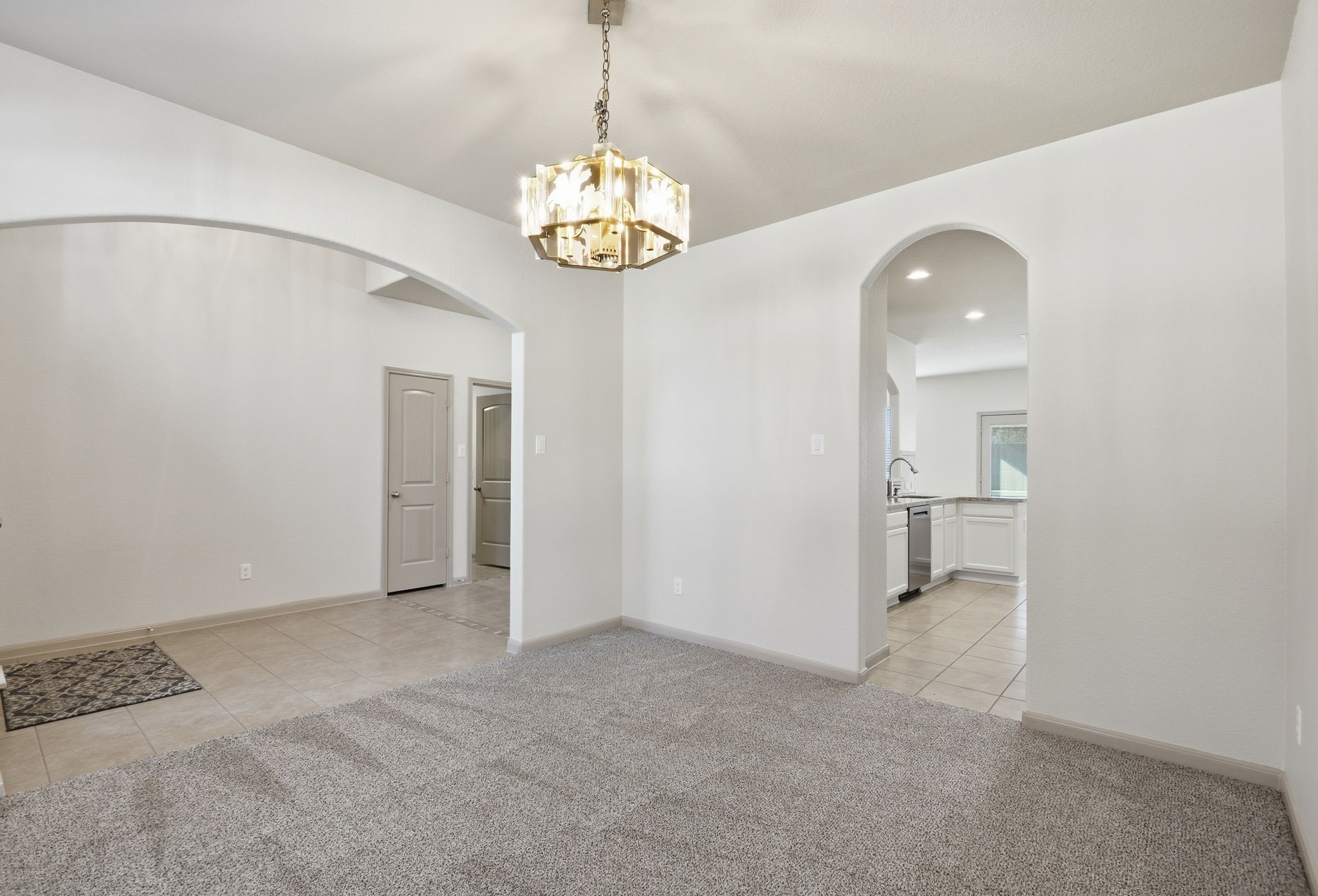 25523 Marmite Drive Tomball, TX 77375 - Photo 8 of 50 a view of a hallway with a chandelier