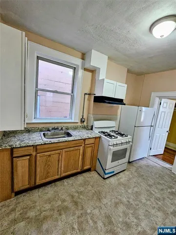 a kitchen with stainless steel appliances granite countertop a stove and a sink