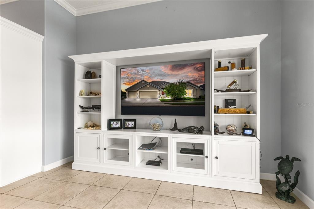 8065 Bridgeport Bay Circle Mount Dora, FL 32757 - Photo 18 of 60 a living room with stainless steel appliances furniture and a flat screen tv