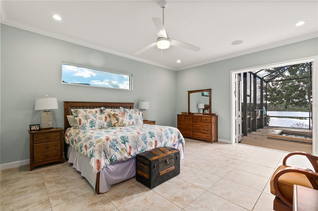 8065 Bridgeport Bay Circle Mount Dora, FL 32757 - Photo 19 of 60 a bedroom with a large bed and a balcony