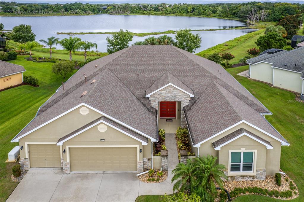 8065 Bridgeport Bay Circle Mount Dora, FL 32757 - Photo 2 of 60 a front view of a house with a yard and garage