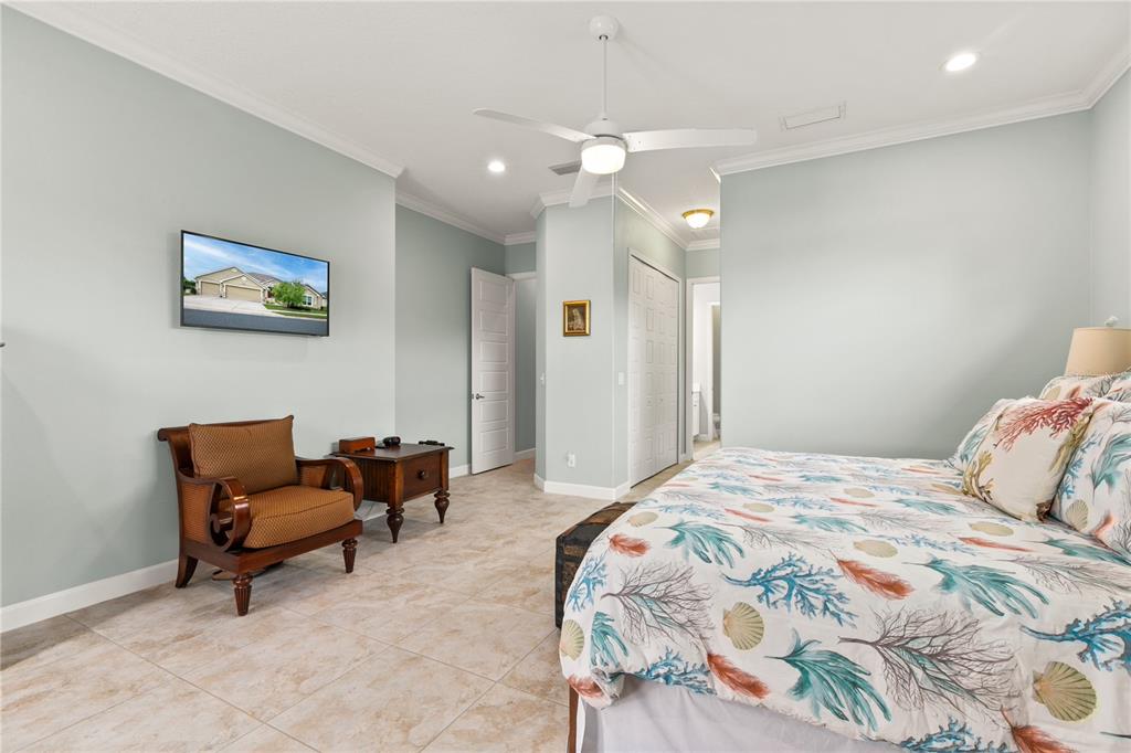 8065 Bridgeport Bay Circle Mount Dora, FL 32757 - Photo 22 of 60 a bedroom with a bed and a couch