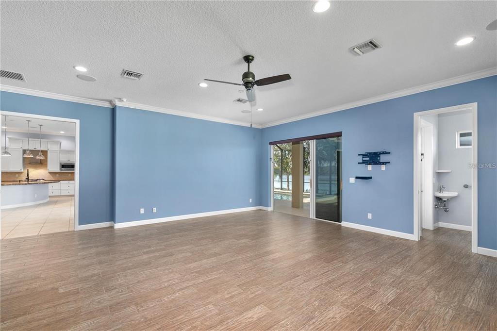8065 Bridgeport Bay Circle Mount Dora, FL 32757 - Photo 28 of 60 a view of an empty room with window and wooden floor