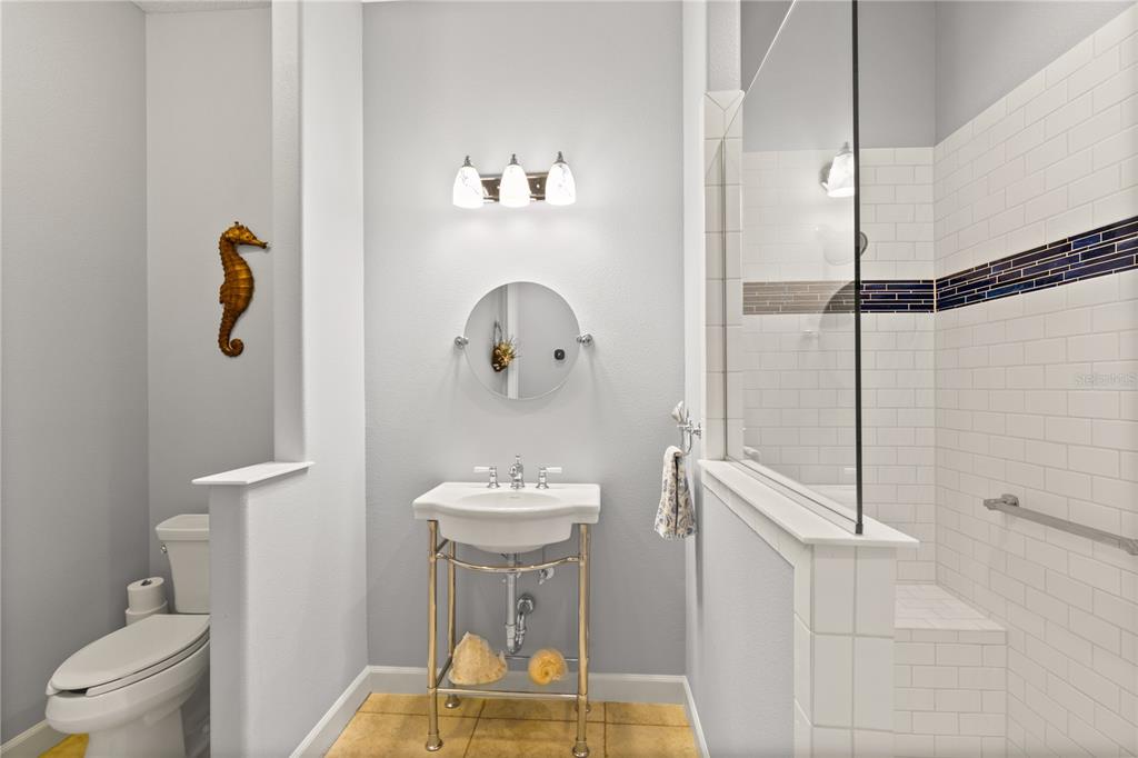 8065 Bridgeport Bay Circle Mount Dora, FL 32757 - Photo 32 of 60 a bathroom with a sink toilet and shower