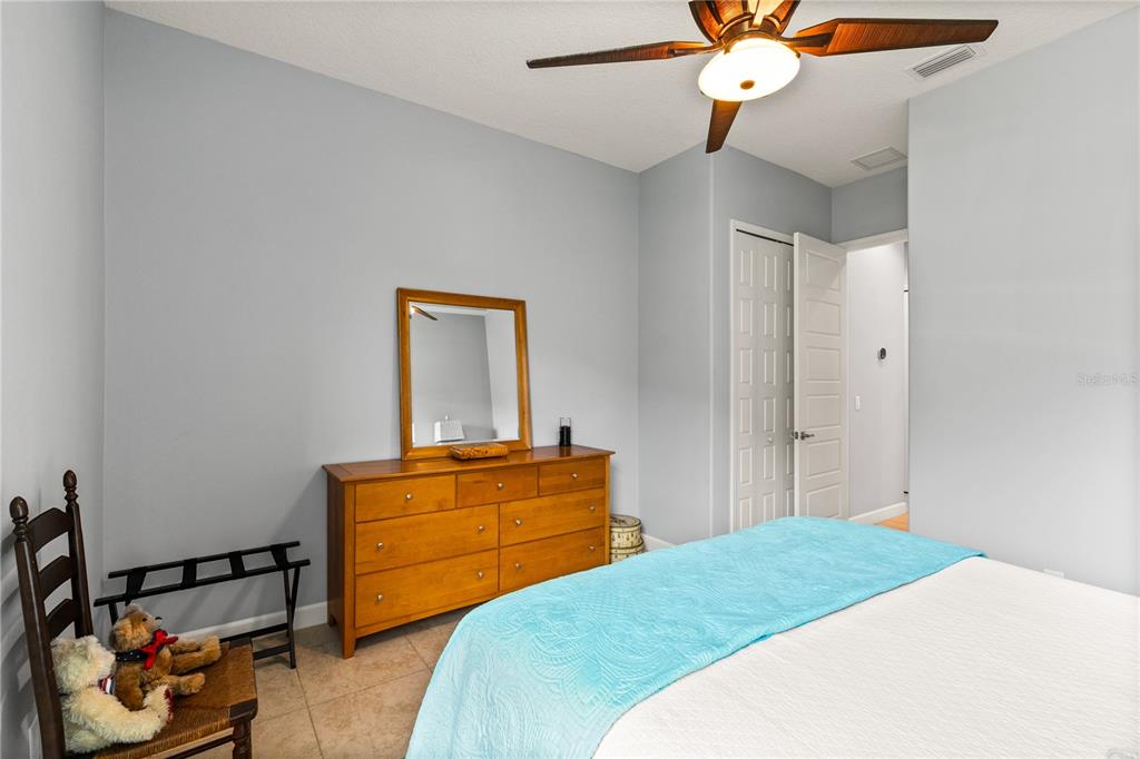 8065 Bridgeport Bay Circle Mount Dora, FL 32757 - Photo 36 of 60 a bedroom with a bed and wooden floor