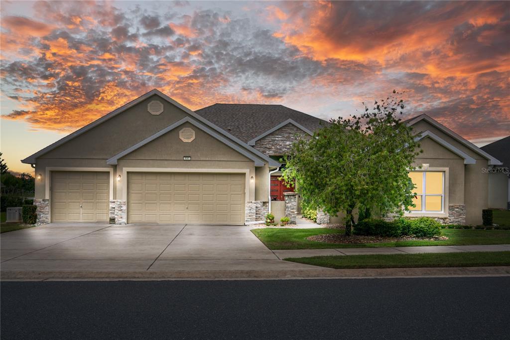 8065 Bridgeport Bay Circle Mount Dora, FL 32757 - Photo 40 of 60 a front view of a house with a yard and garage