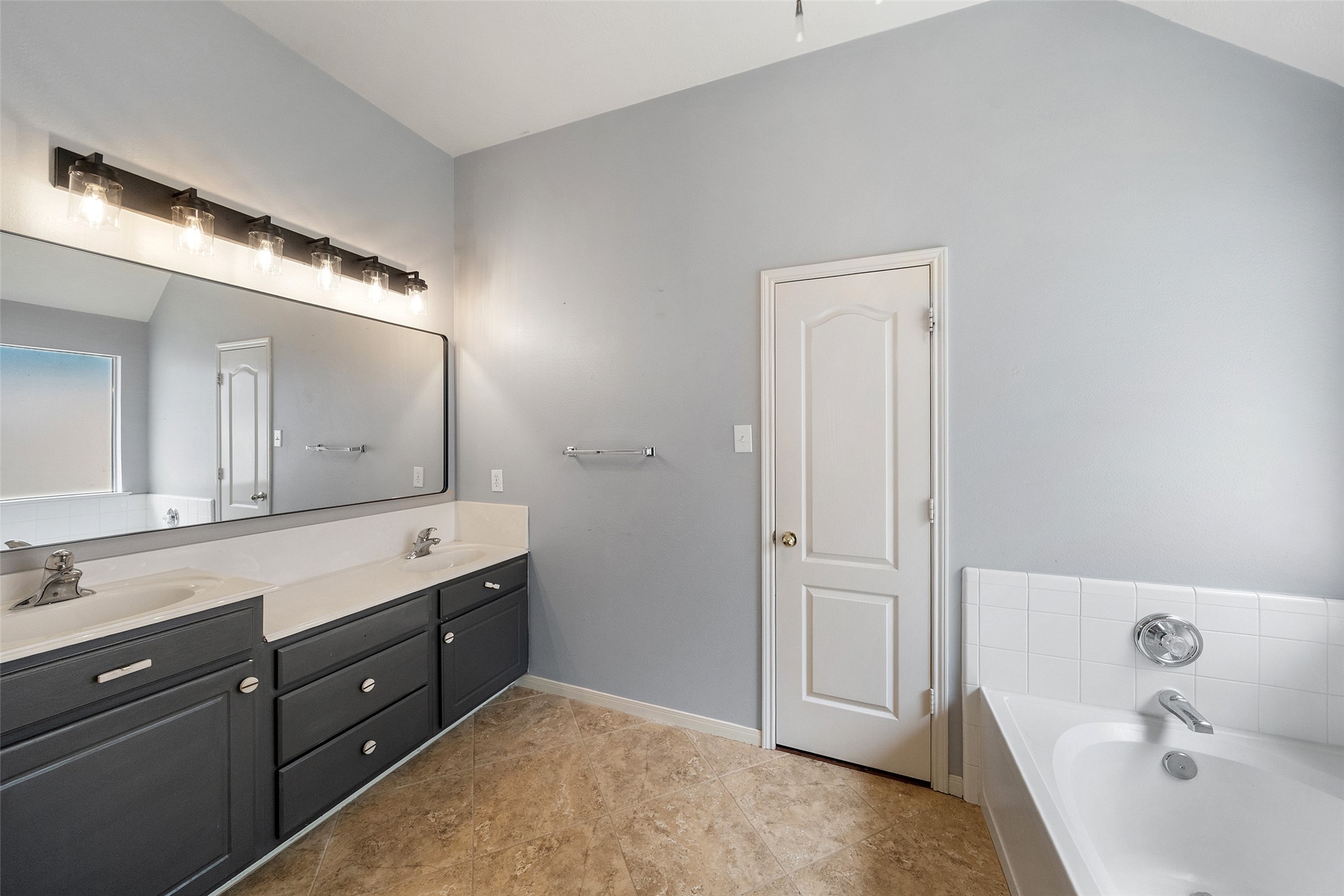 19718 Teller Boulevard Spring, TX 77388 - Photo 23 of 47 a bathroom with a tub sink and mirror