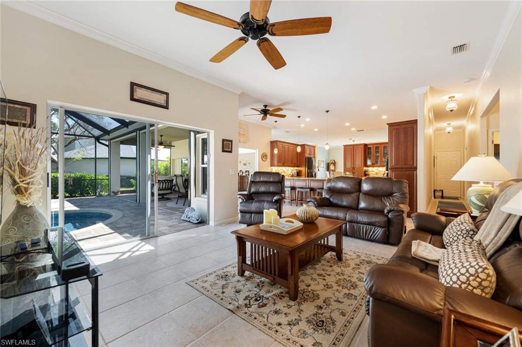2035 Teagarden Lane Naples, FL 34110 - Photo 7 of 21 a living room with furniture or couch and a floor to ceiling window