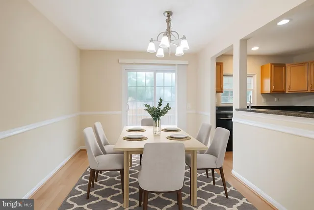 a view of a hallway with wooden floor and chandelier