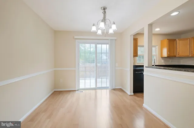a kitchen with granite countertop a refrigerator and a stove top oven