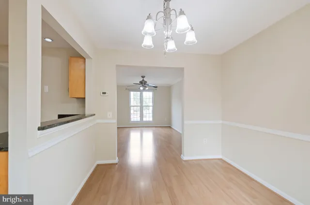 a kitchen with granite countertop white cabinets and sink