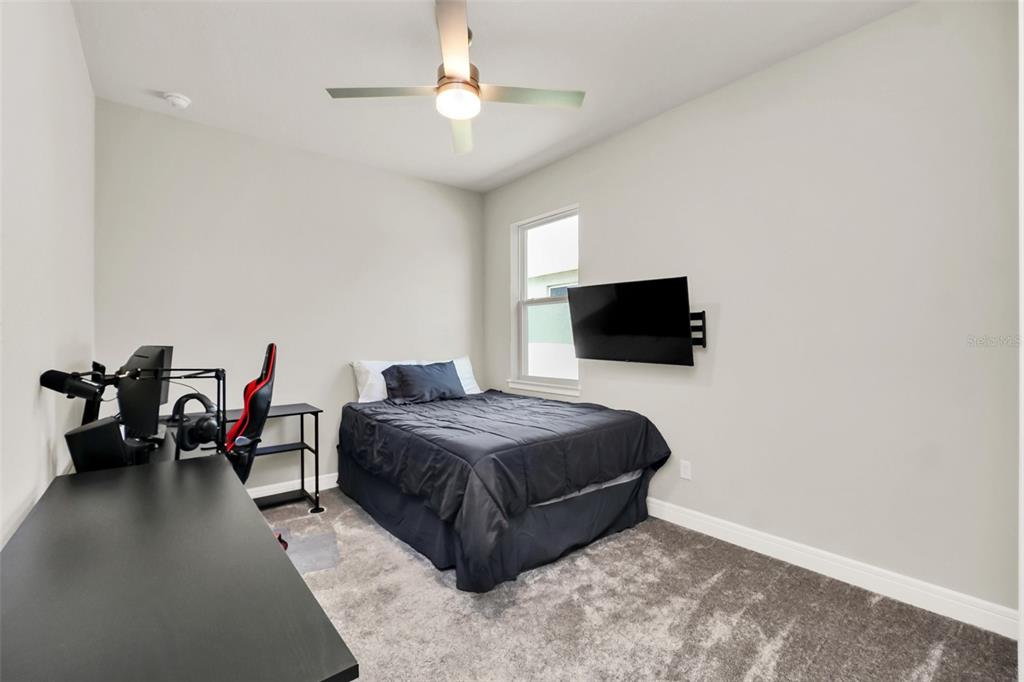 2001 Spring Shower Circle Kissimmee, FL 34744 - Photo 21 of 25 a living room with a bed and a flat screen tv
