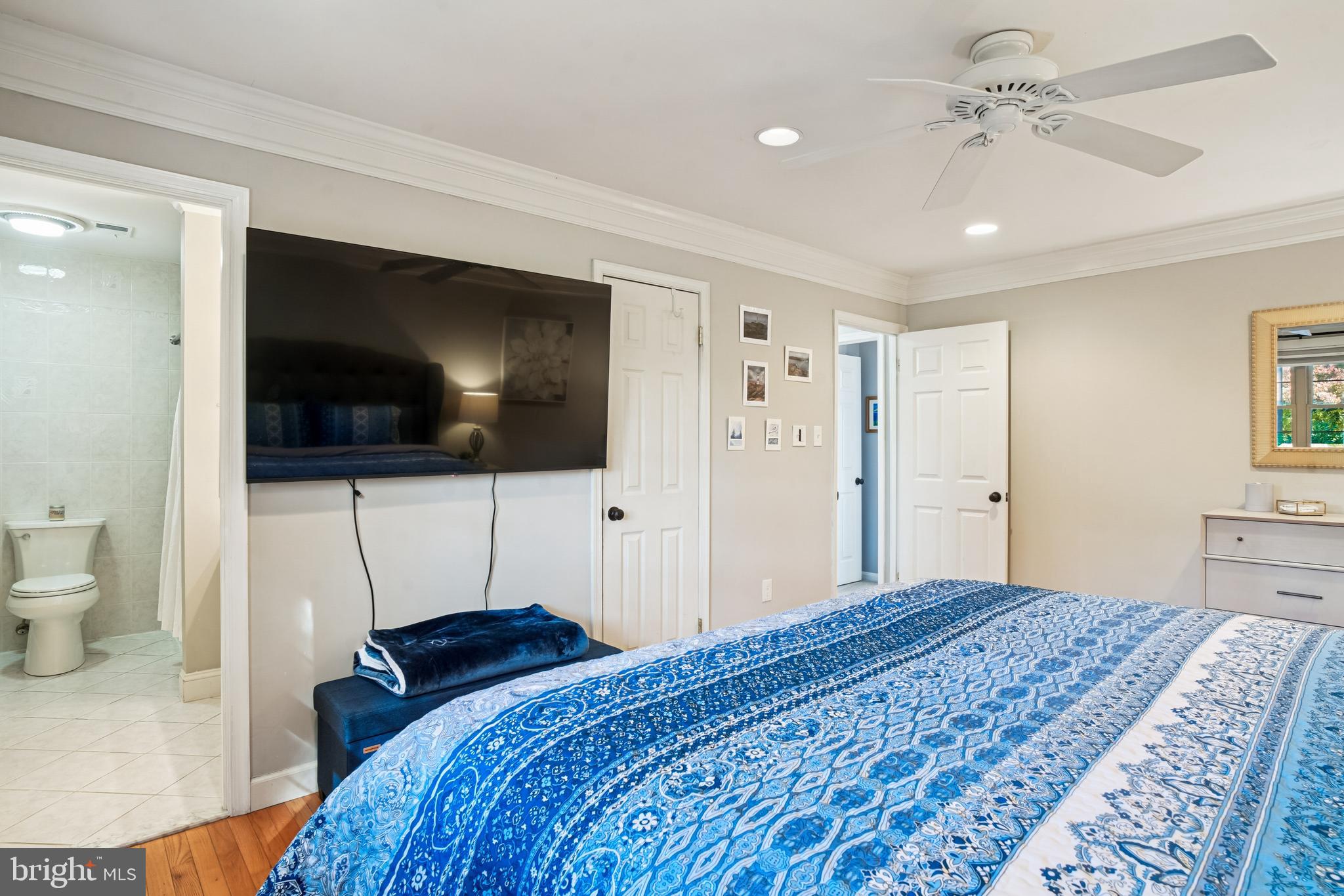 10408 Windfall Court Damascus, MD 20872 - Photo 18 of 38 a bedroom with a bed and a flat screen tv