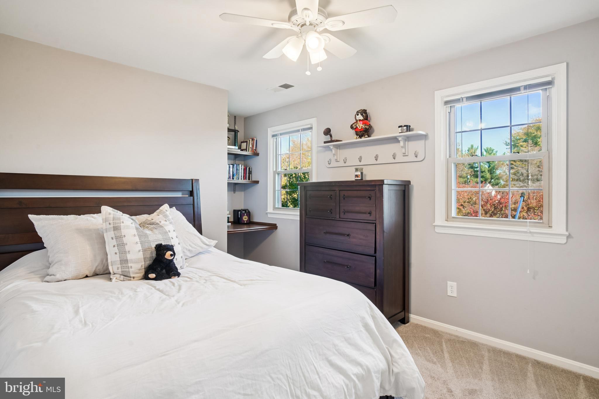 10408 Windfall Court Damascus, MD 20872 - Photo 23 of 38 a bedroom with a bed and a chandelier