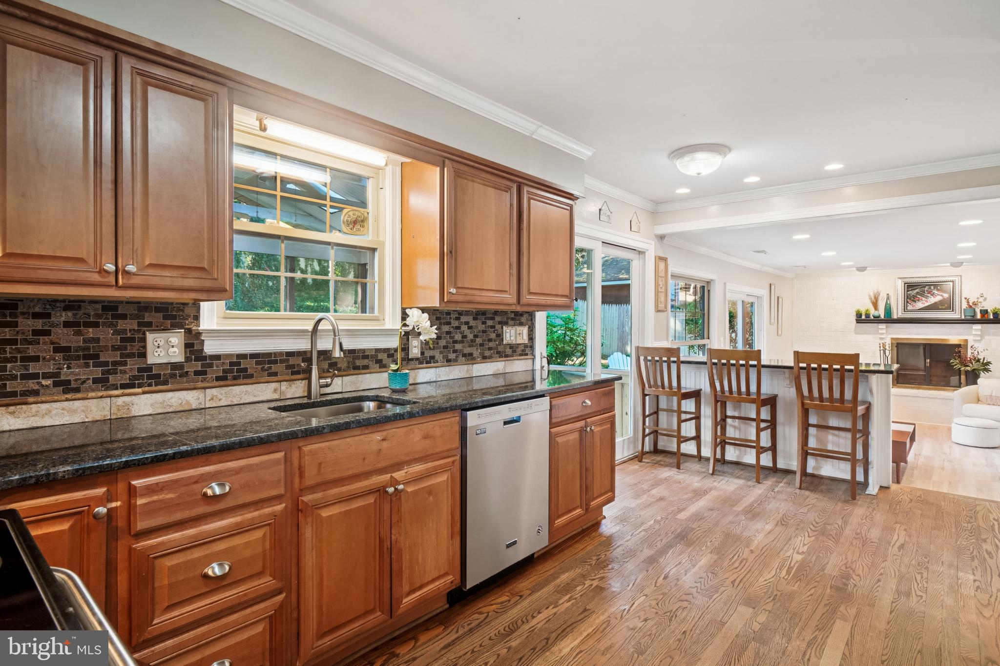 10408 Windfall Court Damascus, MD 20872 - Photo 7 of 38 a kitchen with stainless steel appliances granite countertop a stove a sink and a microwave