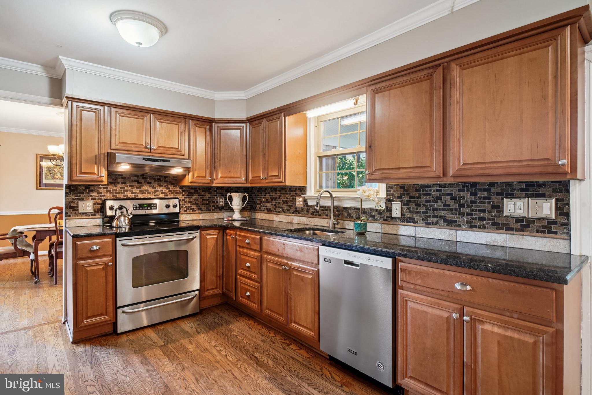 10408 Windfall Court Damascus, MD 20872 - Photo 8 of 38 a kitchen with stainless steel appliances granite countertop a stove a sink and white cabinets