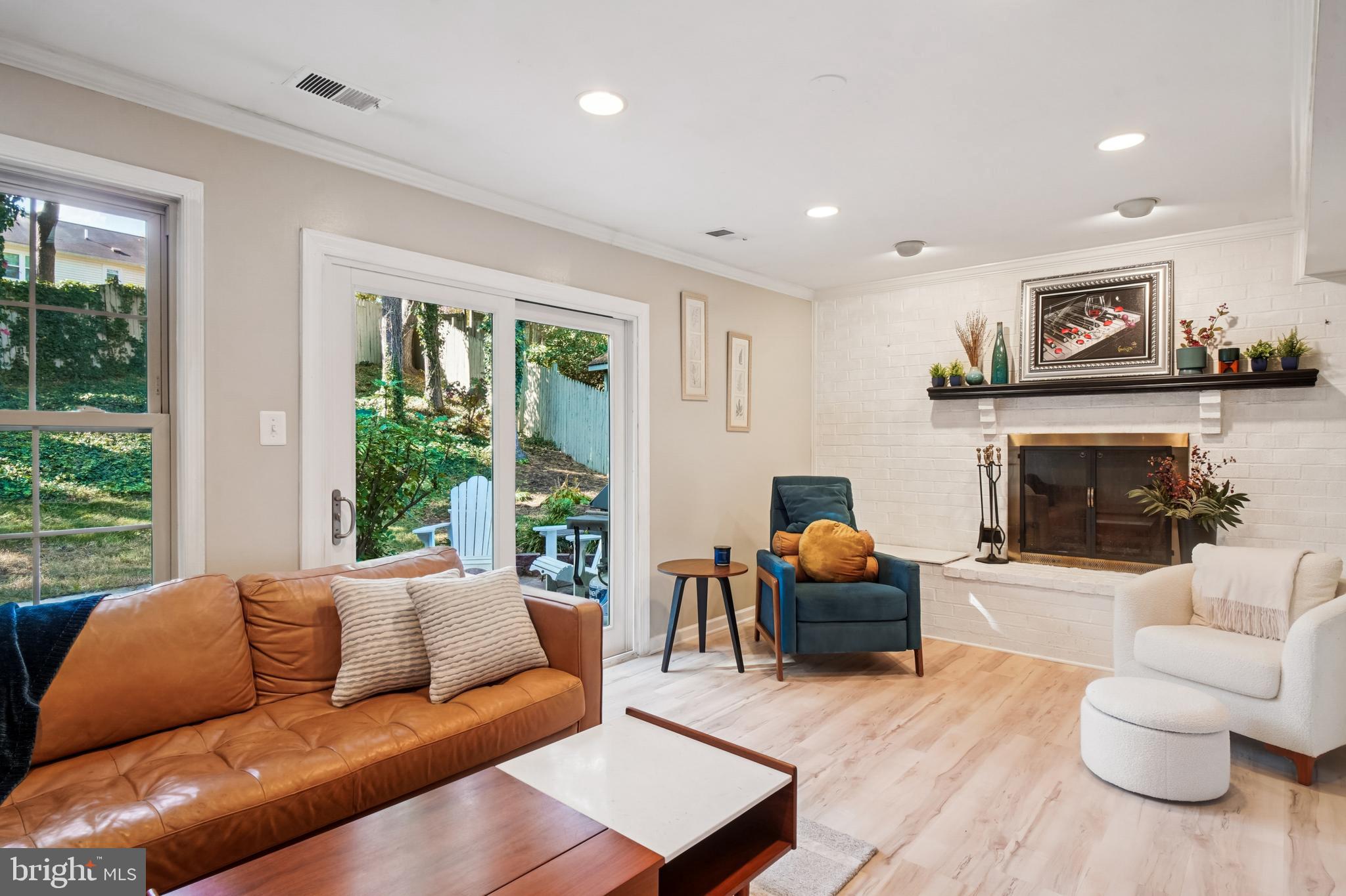 10408 Windfall Court Damascus, MD 20872 - Photo 9 of 38 a living room with furniture a large window and a fireplace
