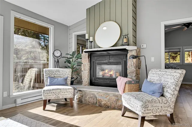 a living room with furniture a window and a fireplace