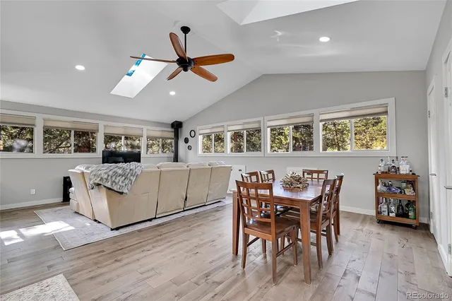 a living room with furniture and kitchen view