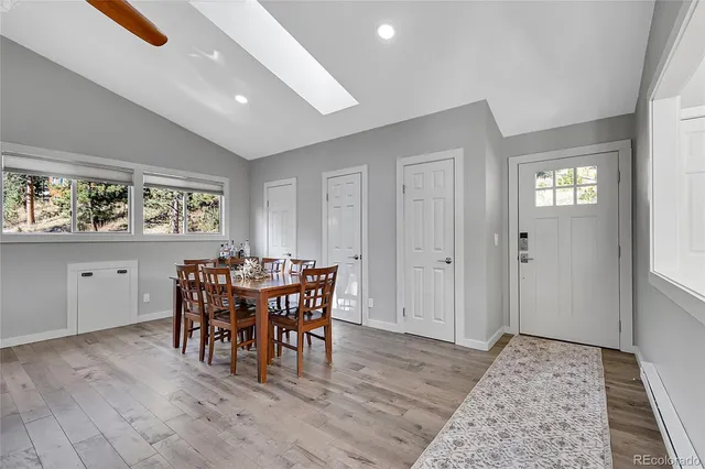 a view of a dining room with furniture and chandelier