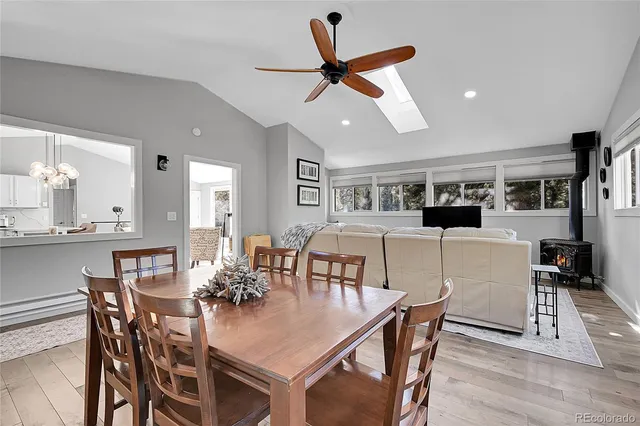 a view of a dining room with furniture and a kitchen