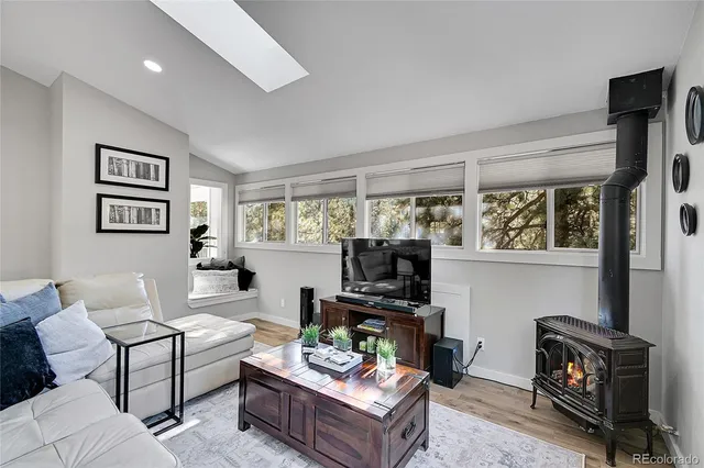 a living room with furniture a flat screen tv and a window