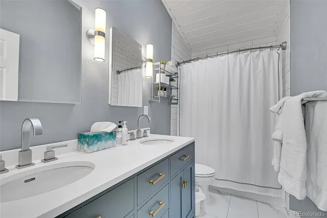 a bathroom with a double vanity sink and mirror