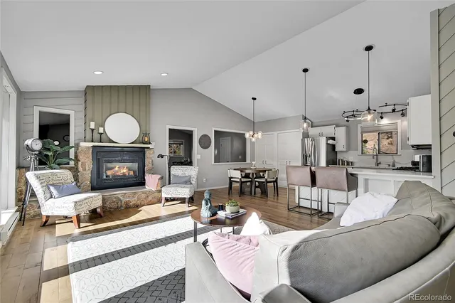 a living room with furniture a fireplace and a flat screen tv
