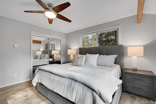 a bedroom with a bed and a lamp on dresser