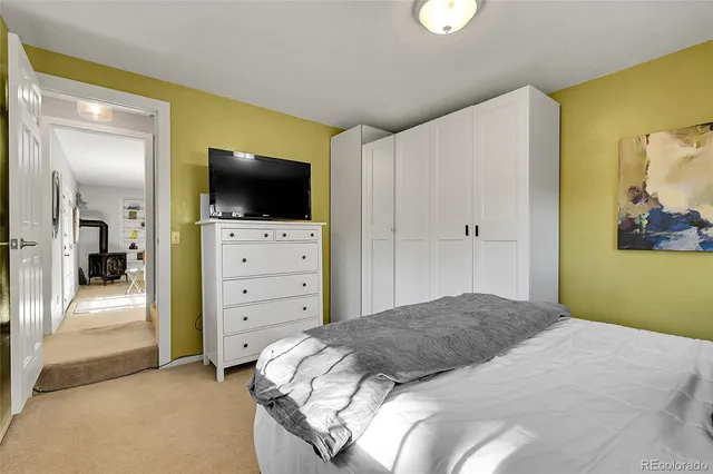 a bedroom with a bed and flat screen tv