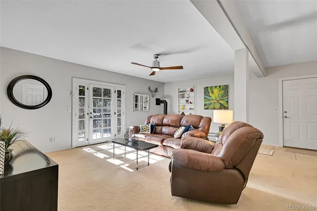 a living room with furniture a window and a chandelier