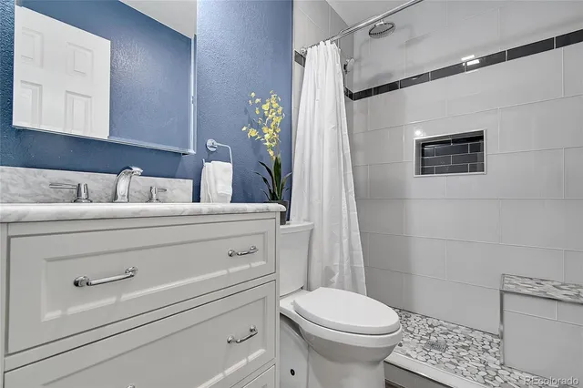 a bathroom with a sink mirror vanity and toilet