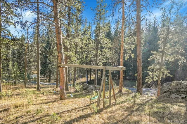 a view of a small house with a tree in the background