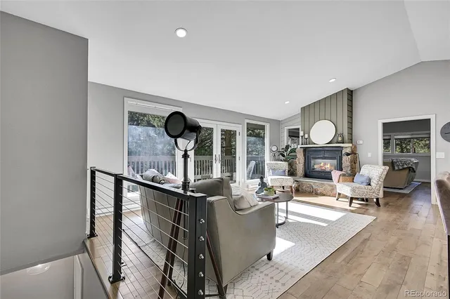 a living room with fireplace furniture and a large window