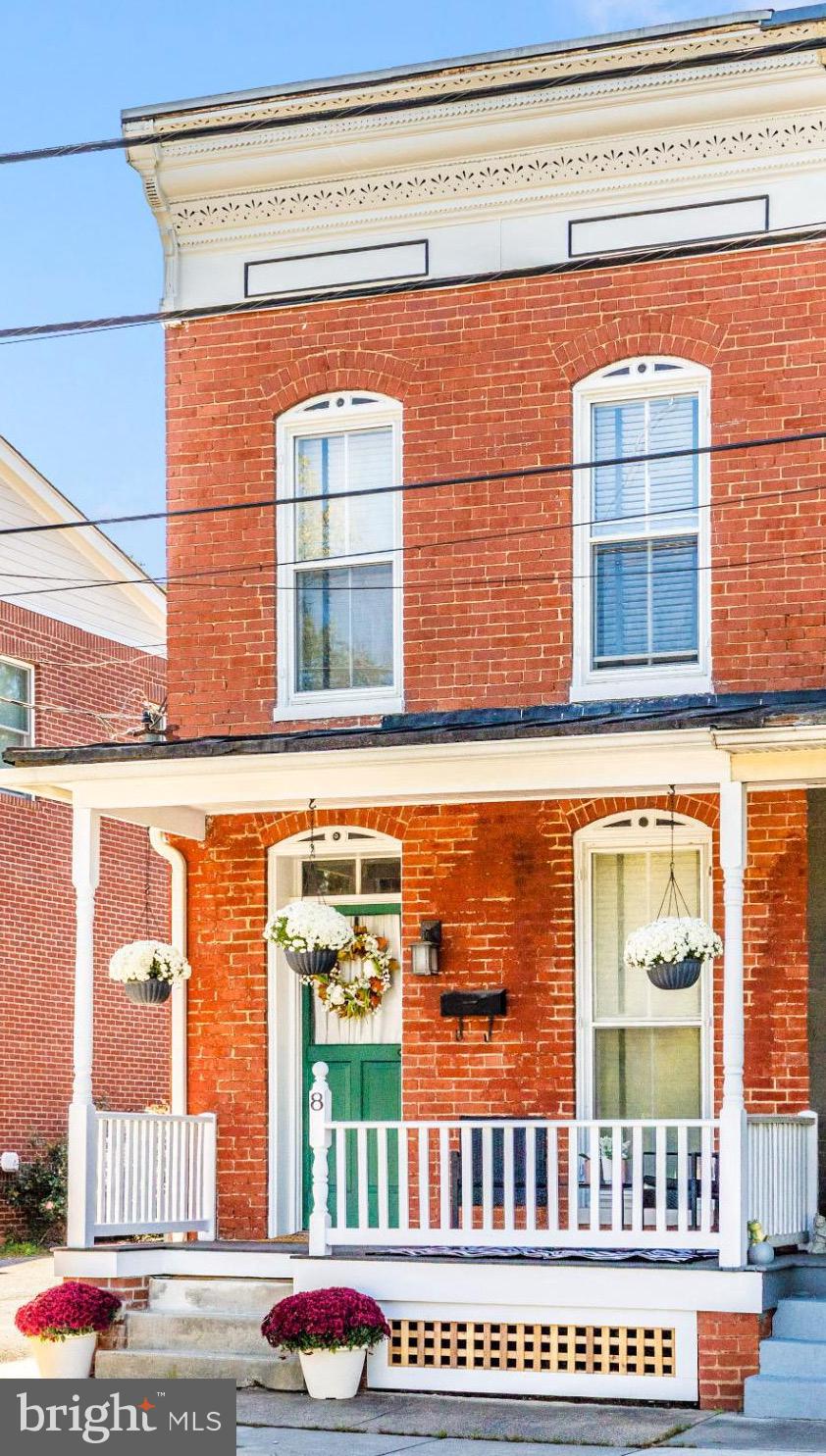Stunning brick townhome with front porch