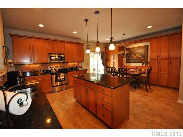 1156 Spicewood Pines Road Fort Mill, SC 29708 - Photo 1 of 16 a kitchen with stainless steel appliances granite countertop a stove a sink and a refrigerator