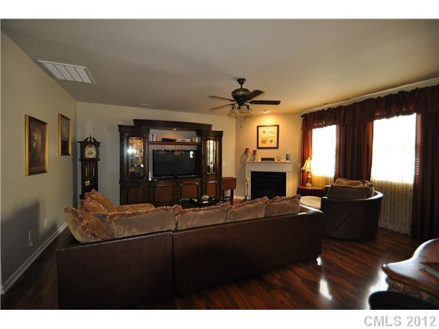 1156 Spicewood Pines Road Fort Mill, SC 29708 - Photo 5 of 16 a living room with furniture a fireplace and a flat screen tv