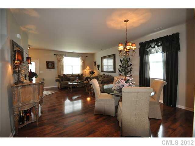 1156 Spicewood Pines Road Fort Mill, SC 29708 - Photo 6 of 16 a living room with furniture a dining table and a chandelier
