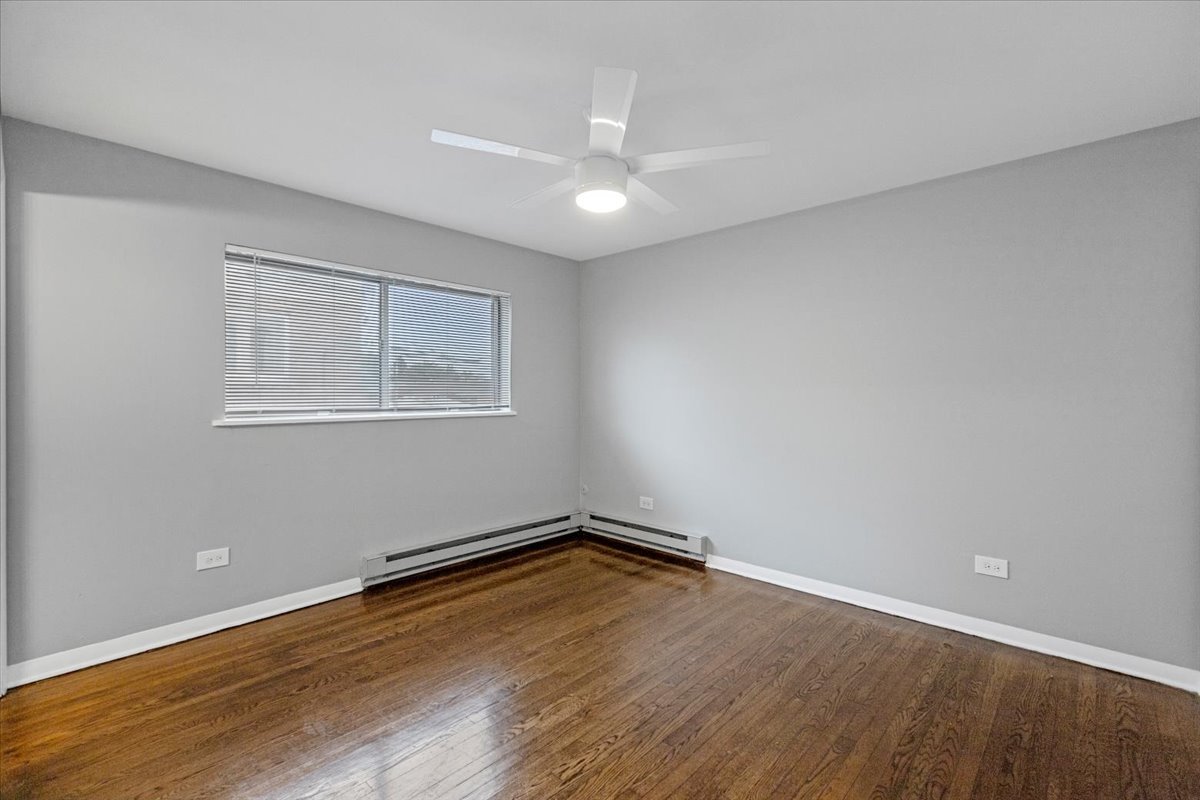 6212 West 64th Place, Unit 202 Chicago, IL 60638 - Photo 19 of 28 a view of a room with wooden floor and window