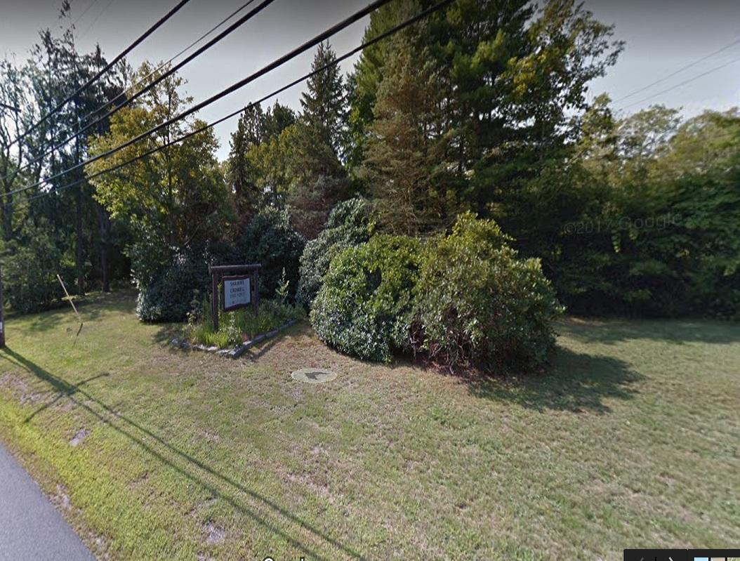 37 Main Street Sandwich, MA 02563 - Photo 4 of 4 a view of a backyard with plants and a bench