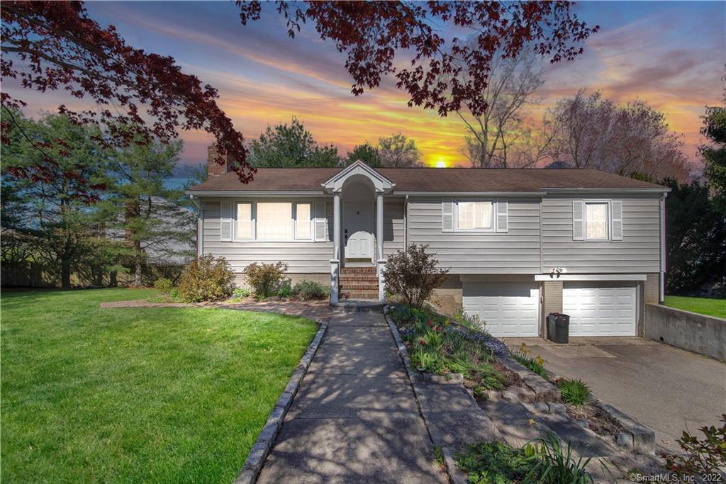 45 Grassland Road Milford, CT 06461 - Photo 1 of 1 a front view of a house with a yard and garden